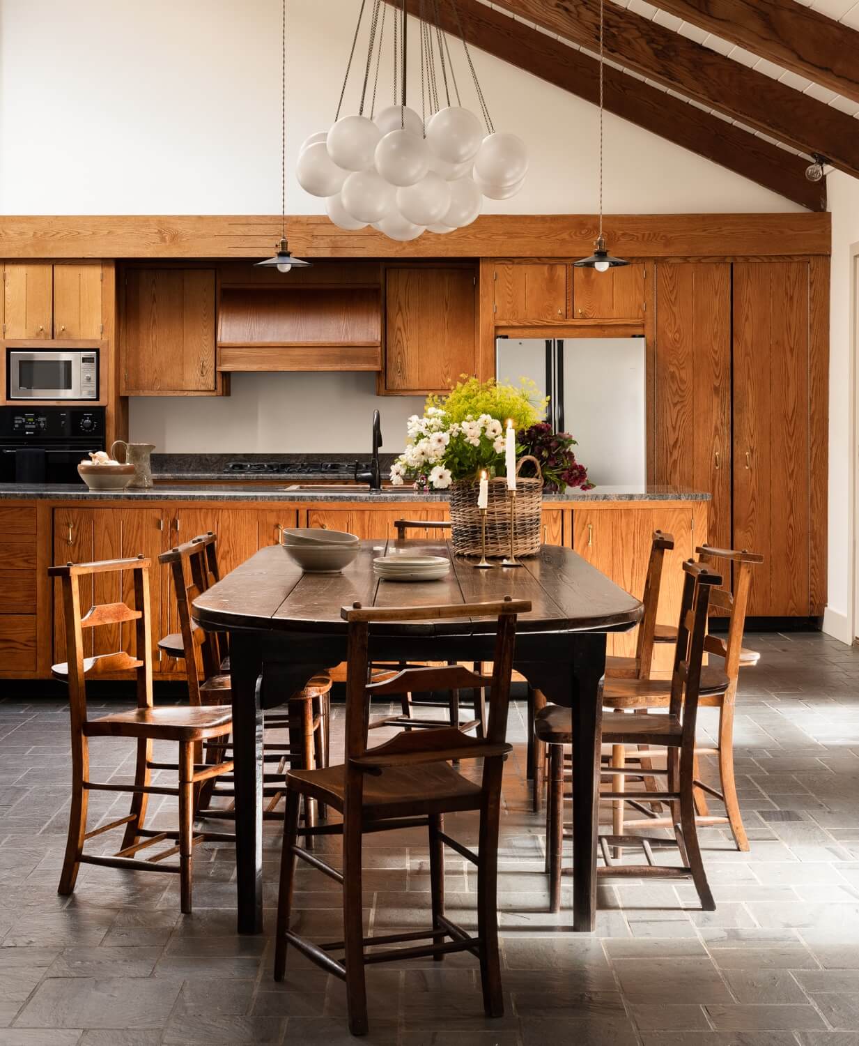 A Warm Country House in Dutchess County 5 Heidi-Caillier-Design-CT-country-house-Dutchess-County-design-dining-room-beams-rustic-table-vintage-art-kitchen-wood-cabinets-Nordroom
