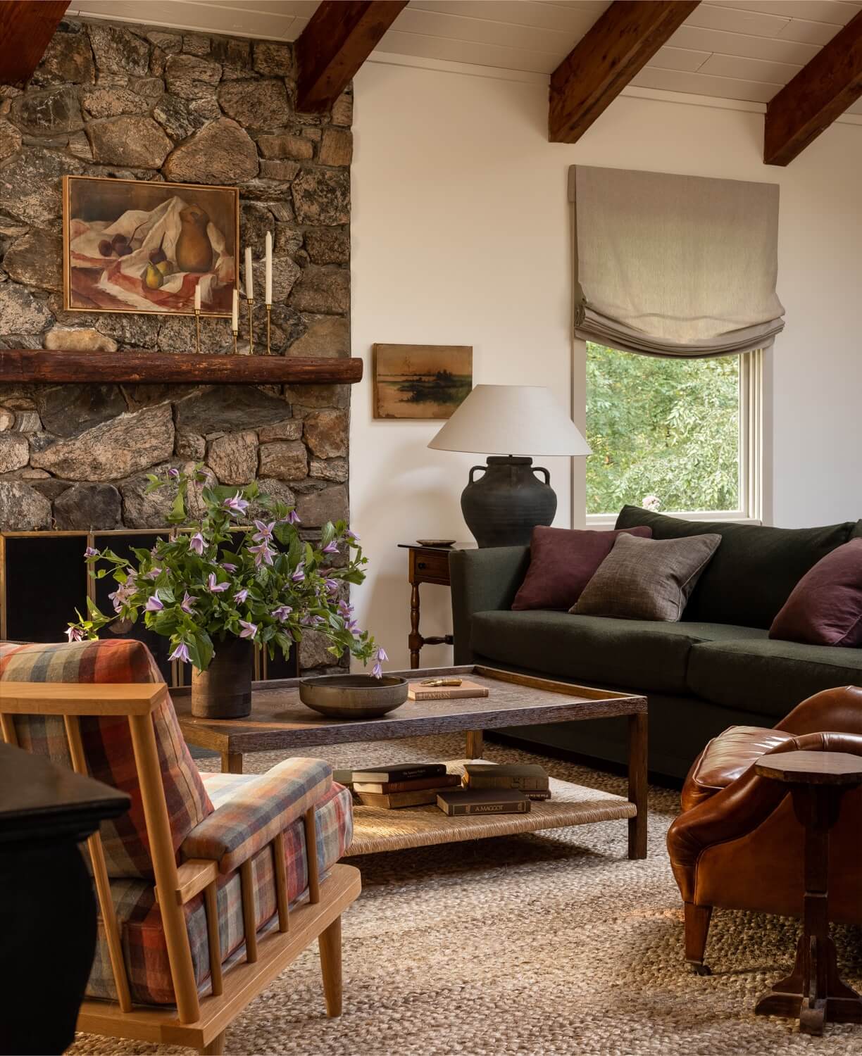 A Warm Country House in Dutchess County 3 Heidi-Caillier-Design-CT-country-house-Dutchess-County-design-living-room-stone-fireplace-beams-jute-rug-spindle-chairs-Nordroom