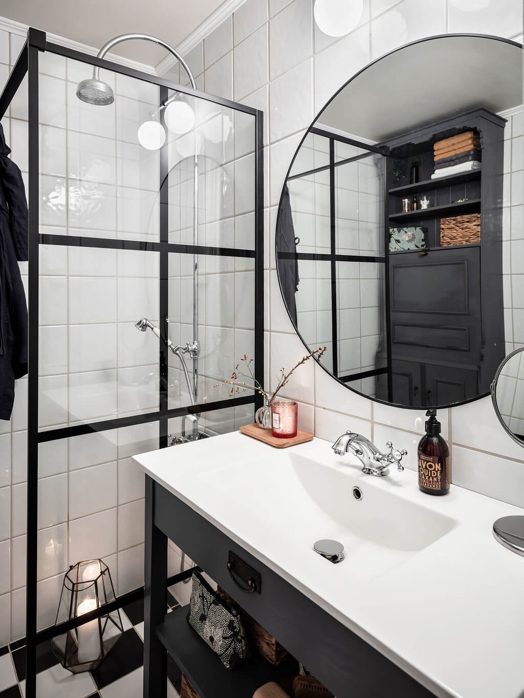 A Bright Nordic Home with Small (but Smartly Designed) Bedrooms 27 bathroom-dark-blue-vanity-round-mirror-nordroom