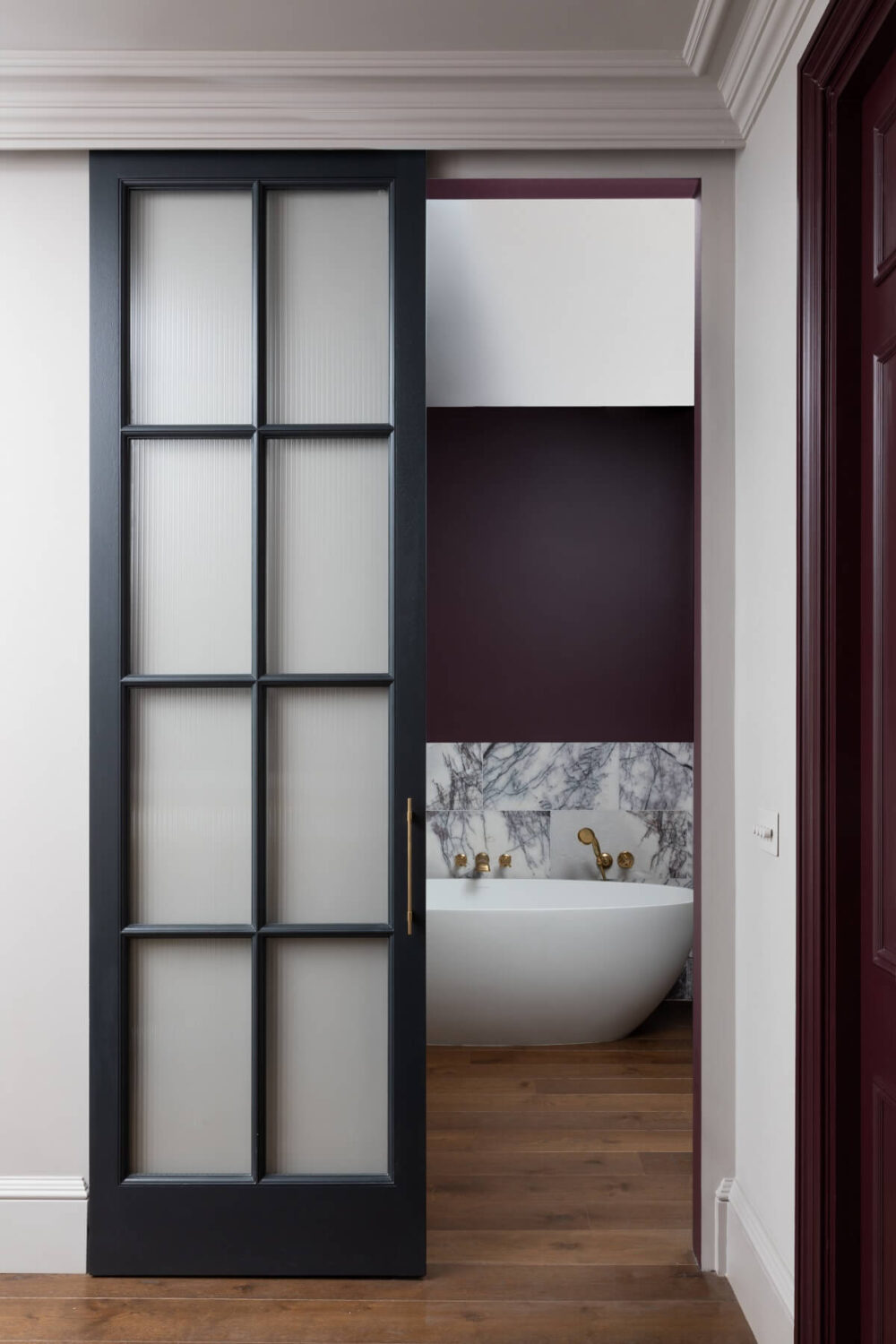 A Victorian Home in London with Bold Color Accents 18 bathroom-sliding-doors-freestanding-bath-burgundy-wall-color-marble-tiles-wooden-floor-nordroom
