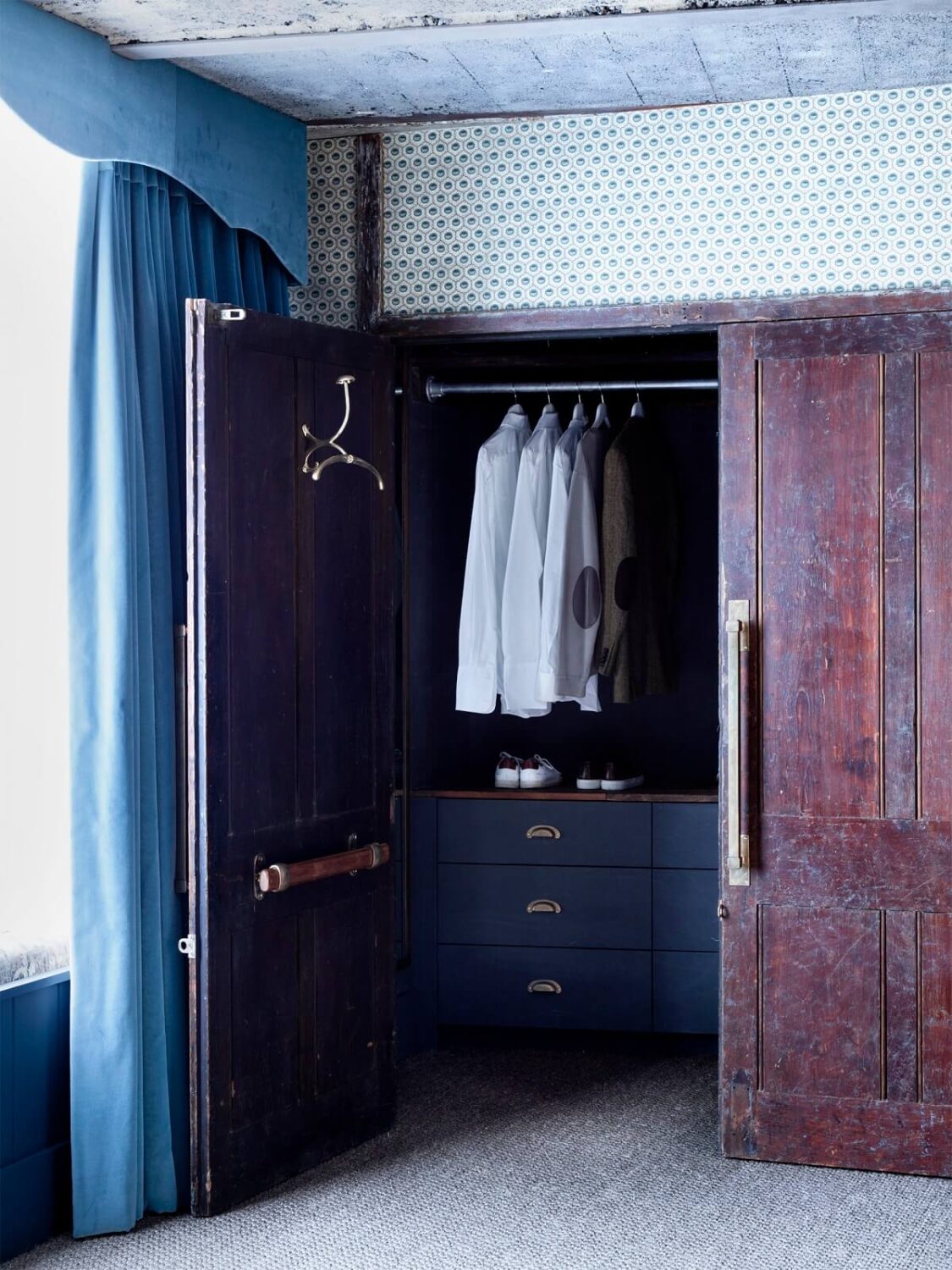 An Industrial Apartment by Mark Lewis Interior Design 13 bedroom-closet-reclaimed-wooden-doors-blue-color-accents-nordroom