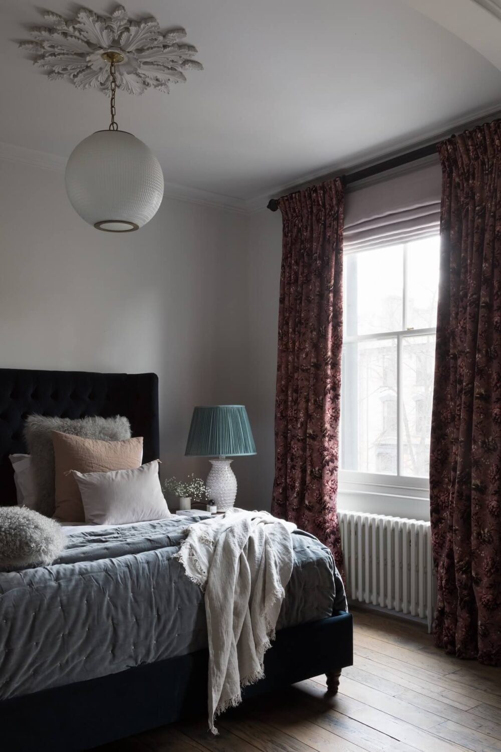 Contrasting Styles in a Victorian Home in London 21 bedroom-dark-blue-velvet-bedframe-ceiling-rosette-victorian-home-london-nordroom