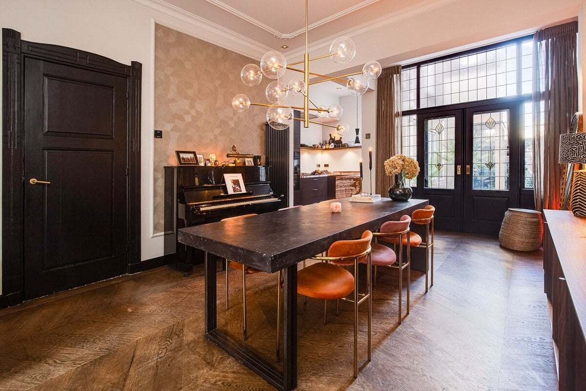 A Dutch Family Home with Warm Color Accents 5 black-dining-table-colorful-chairs-wooden-floor-nordroom