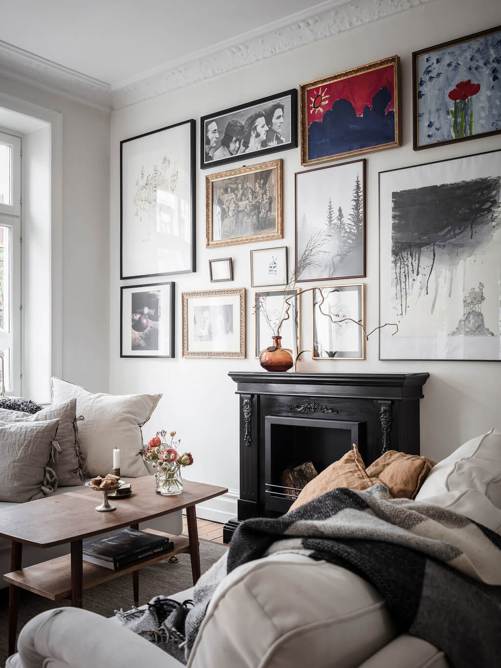 A Bright Nordic Home with Small (but Smartly Designed) Bedrooms 14 black-fireplace-living-room-gallery-wall-nordroom
