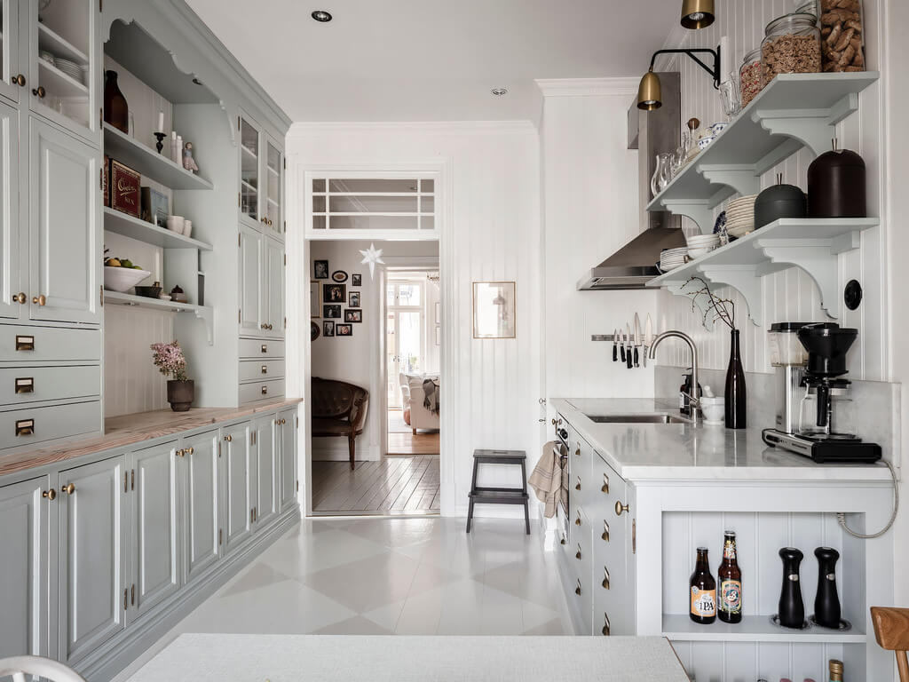 A Bright Nordic Home with Small (but Smartly Designed) Bedrooms 10 bright-charming-kitchen-light-blue-cabinets-open-shelves-nordroom
