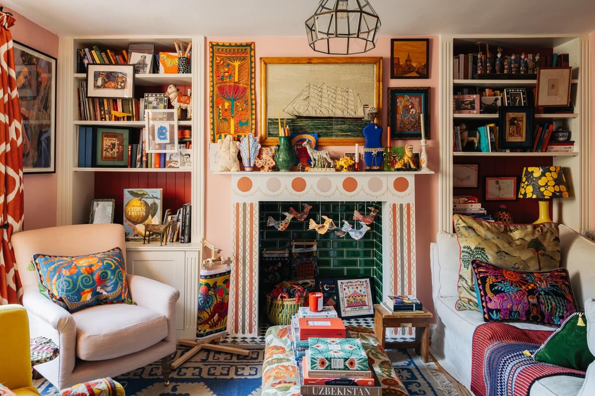 A Playful Maximalist Home in London 2 colorful-maximalist-sitting-room-fireplace-green-tiles-bookshelves-nordroom
