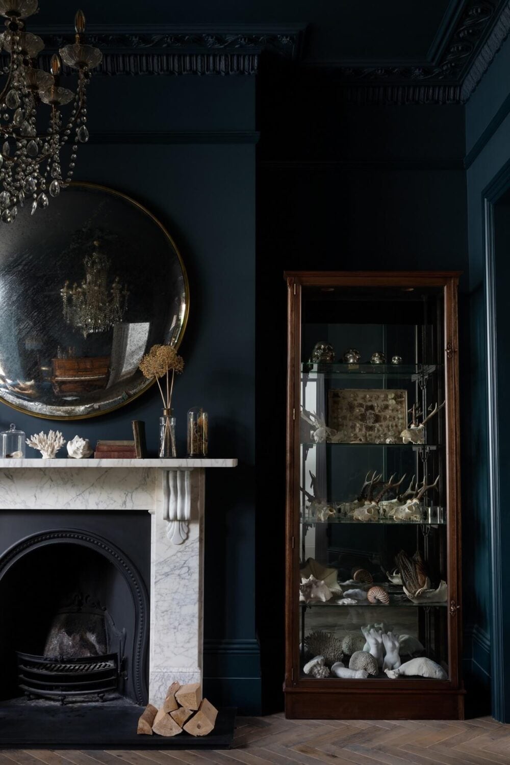 Contrasting Styles in a Victorian Home in London 8 dark-blue-sitting-room-fireplace-round-mirror-glass-cabinet-nordroom