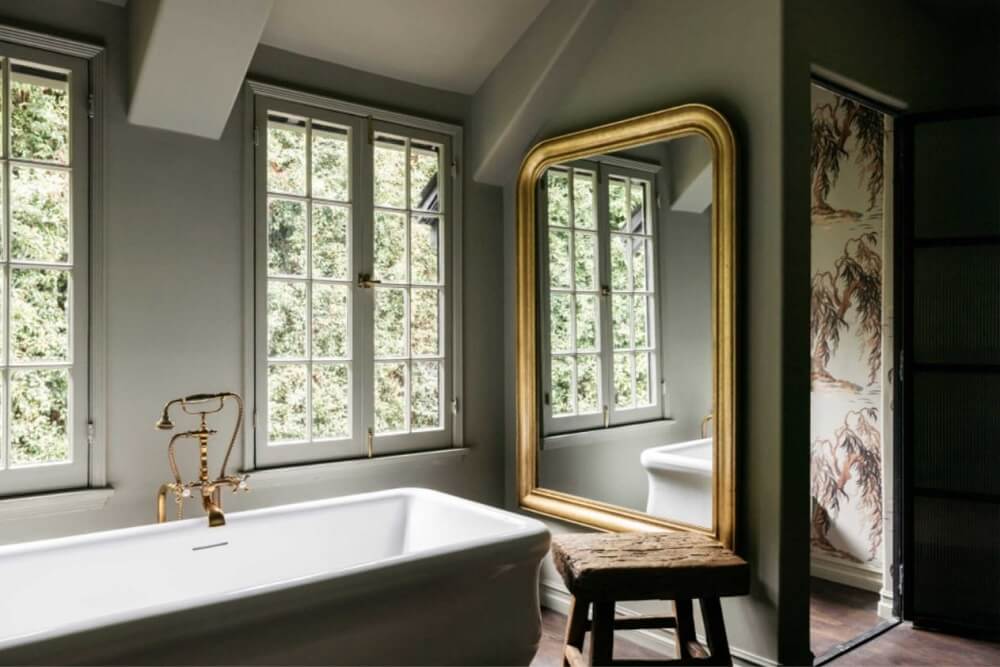 A Beautiful Tudor House in Los Feliz 31 freestanding-bath-green-walls-large-mirror-bathroom-nordroom