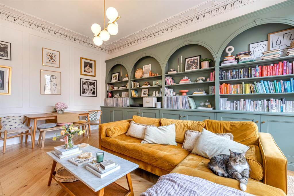 Kate Spiers Sells Her Beautiful Light Flat in Glasgow 3 green-custom-made-bookshelves-arches-yellow-sofa-period-details-glasgow-flat-kate-spiers-nordroom