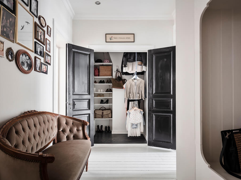 A Bright Nordic Home with Small (but Smartly Designed) Bedrooms 28 hallway-built-in-wardrobe-black-wooden-doors-nordroom