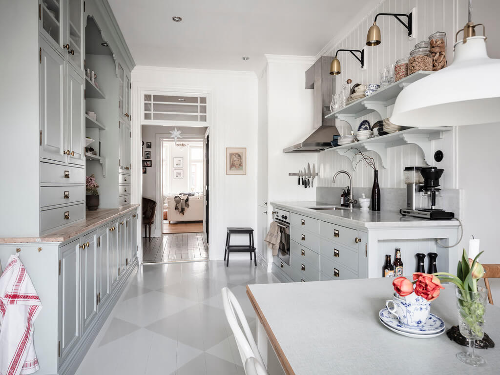 A Bright Nordic Home with Small (but Smartly Designed) Bedrooms 11 kitchen-light-blue-cabinets-painted-floor-boards-nordroom