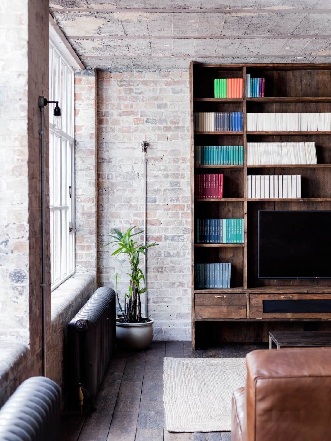 An Industrial Apartment by Mark Lewis Interior Design 8 living-room-wooden-built-in-cabinet-loft-mark-lewis-nordroom