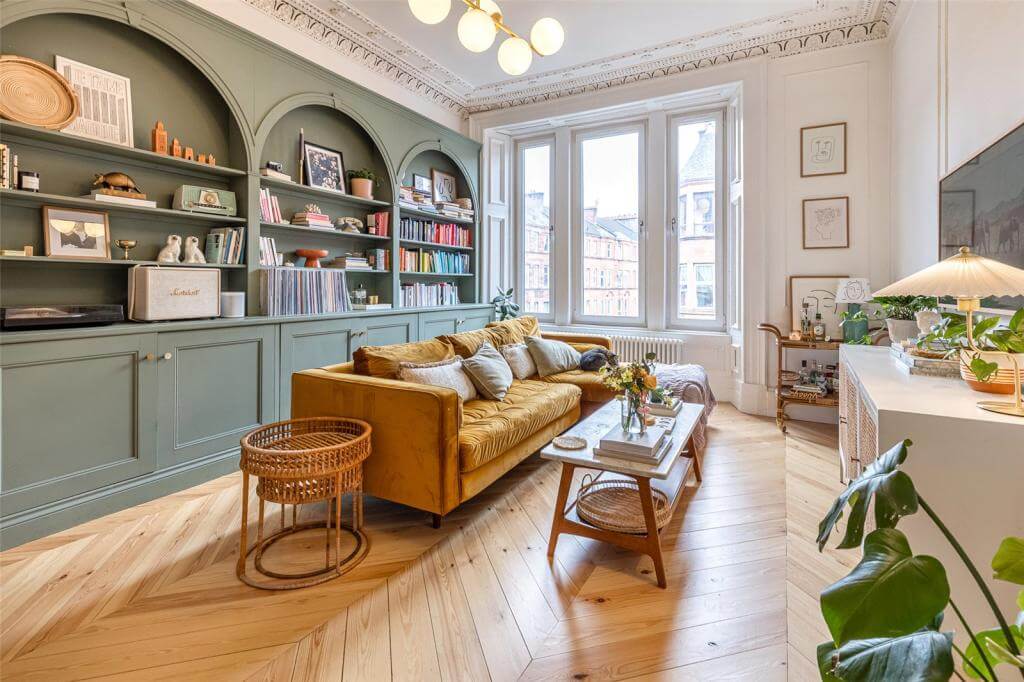 Kate Spiers Sells Her Beautiful Light Flat in Glasgow 2 living-room-wooden-floor-period-details-green-arched-bookshelves-yellow-sofa-kate-spiers-nordroom