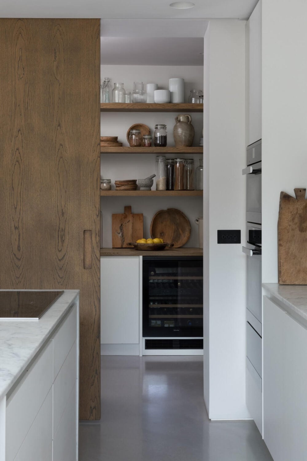 Contrasting Styles in a Victorian Home in London 16 modern-white-kitchen-utility-room-wooden-sliding-door-victorian-home-london-nordroom