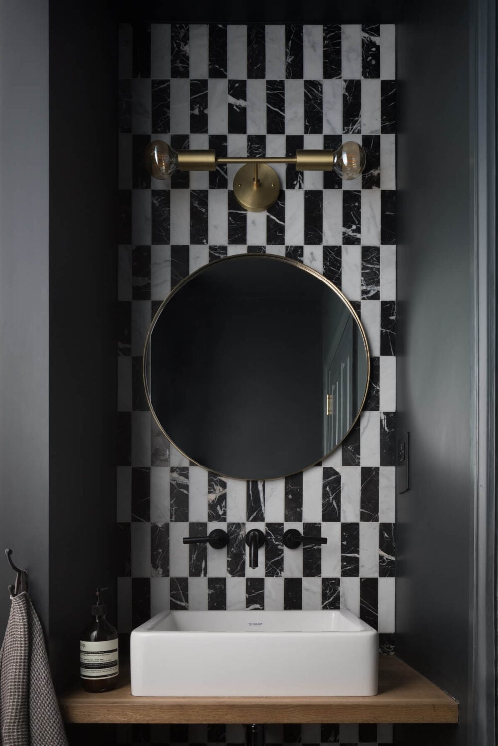 Contrasting Styles in a Victorian Home in London 27 powder-room-round-mirror-black-white-tiles-nordroom