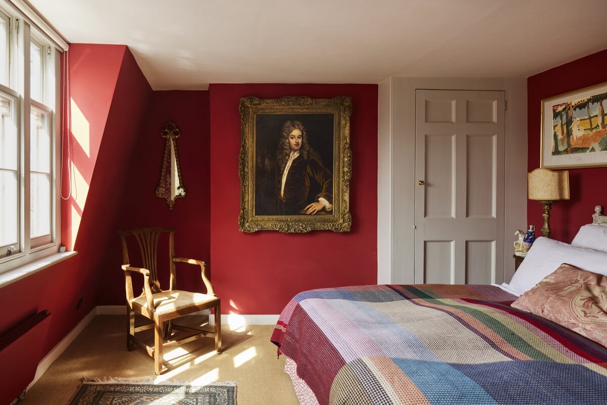 The Best Warm Paint Colors for a Bedroom 7 red-bedroom-portrait-painting-eclectic-london-home-nordroom