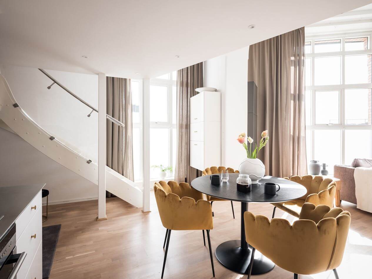 A Light Scandinavian Loft Apartment 9 round-table-yellow-chairs-open-plan-kitchen-living-room-loft-nordroom