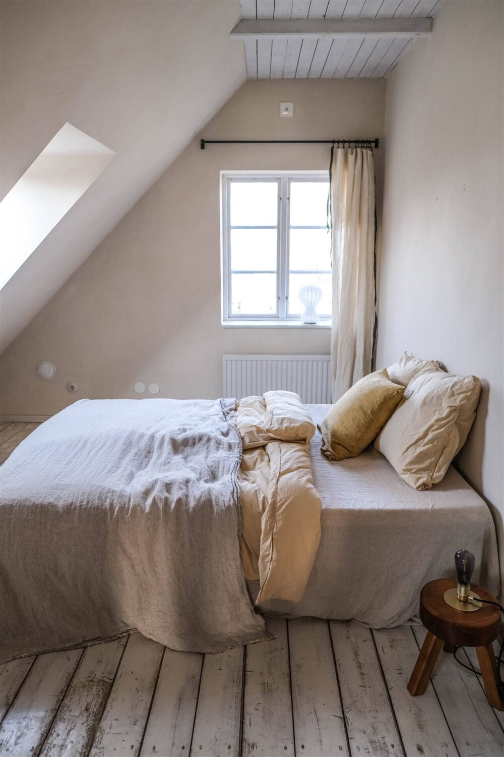 Our Food Stories' Countryside Cottage in Sweden 24 serene-attic-bedroom-wooden-floor-nordroom