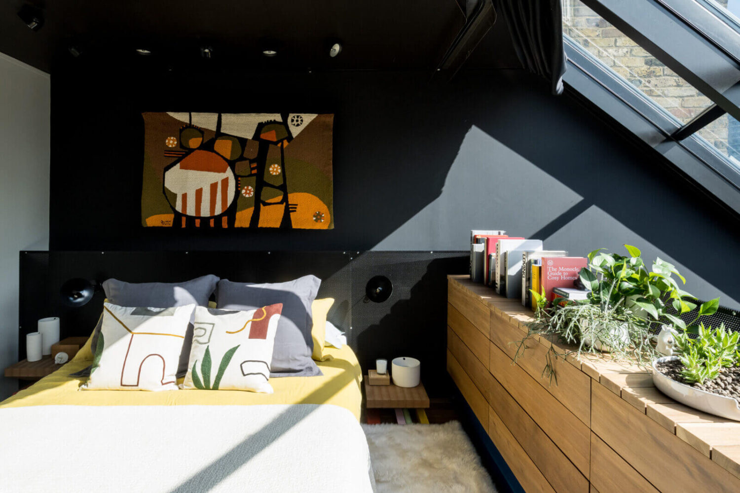 A Spectacular Modern Black Loft in London 12 attic-bedroom-black-walls-wooden-drawers-artist-windows-nordroom