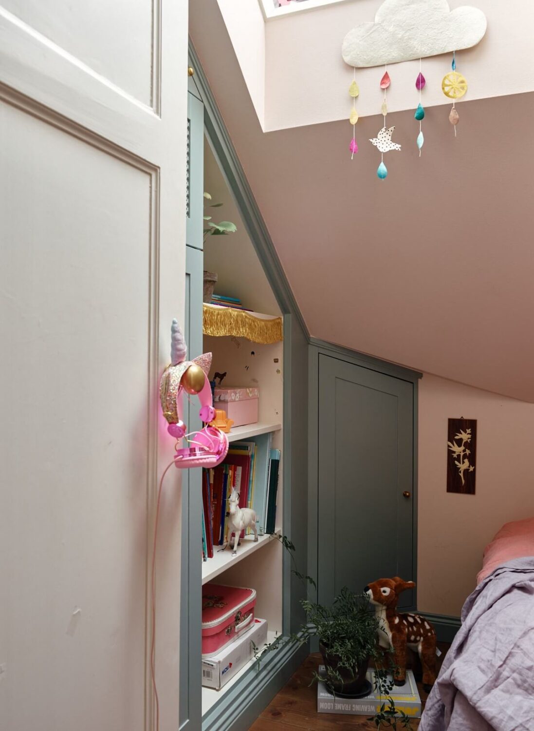 A Cozy Vintage Bohemian Maisonette in Sweden 26 attic-bedroom-closet-under-slanted-ceiling-nordroom