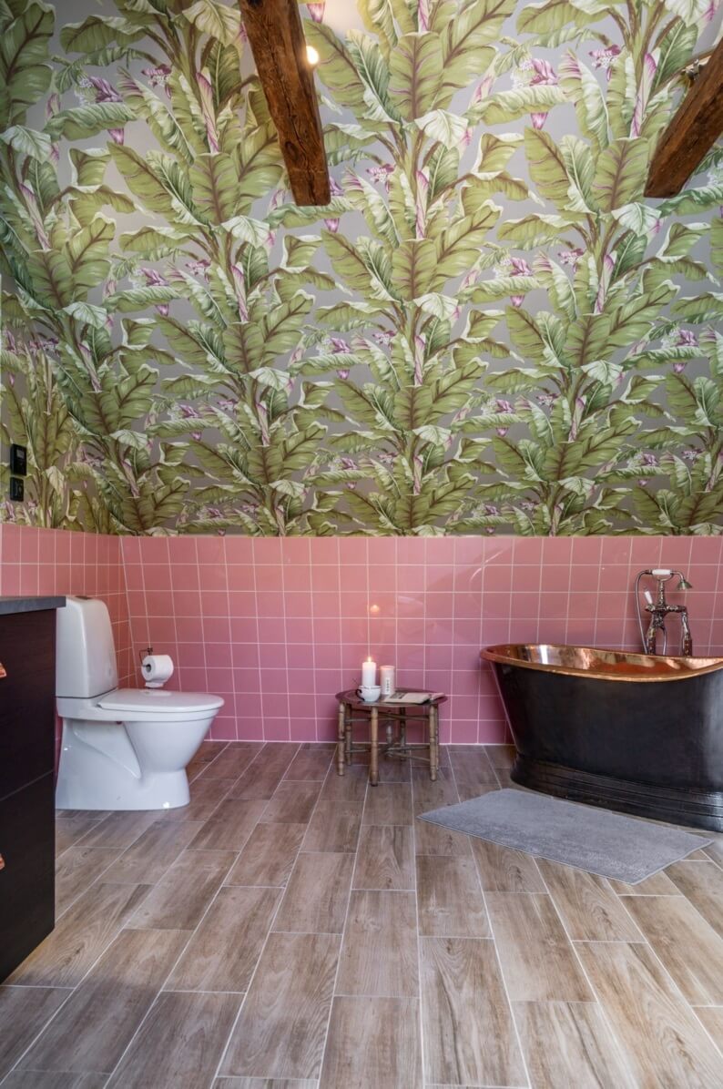 A Colorful Family Home in a Former School Building 30 bathroom-slanted-ceiling-pink-tiles-palm-wallpaper-nordroom