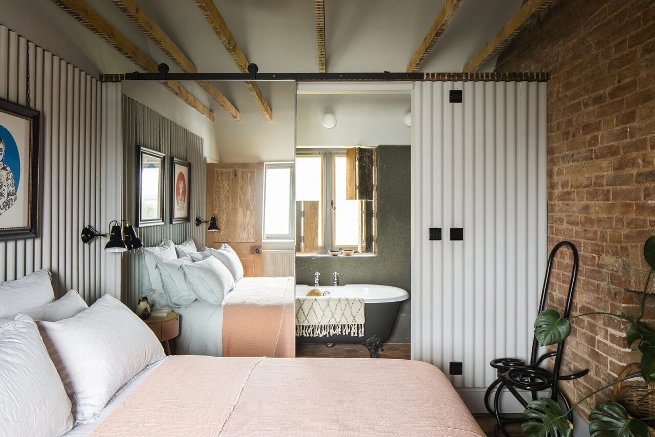 A Cozy Victorian Country House in England 13 bedroom-en-suite-bathroom-brick-wall-clawfoot-bath-mirror-sliding-door-nordroom