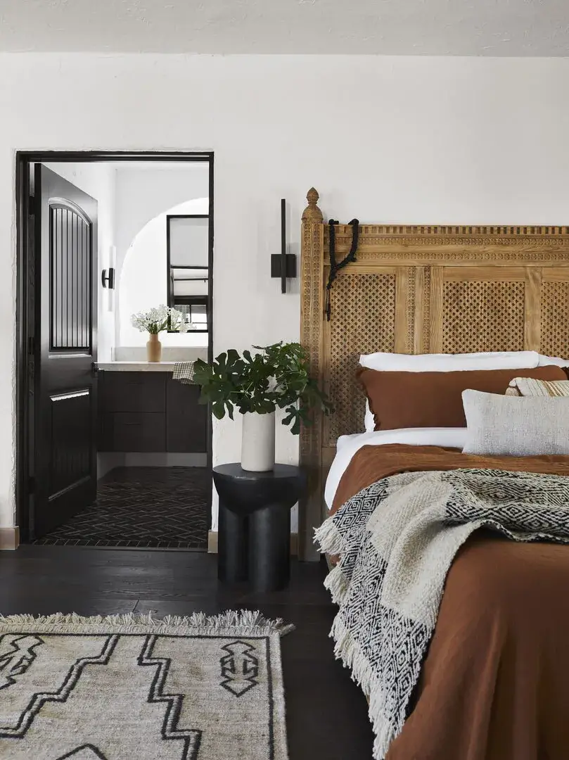 Queer Eye's Bobby Berk Designed An Airbnb Villa in California 6 bedroom-en-suite-wooden-headboard-earthy-color-accents-nordroom