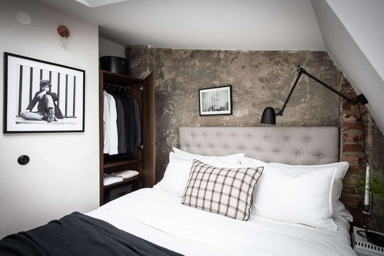 A Light Nordic Attic Loft with Raw Walls and Skylights 14 bedroom-slanted-ceiling-raw-wall-nordroom