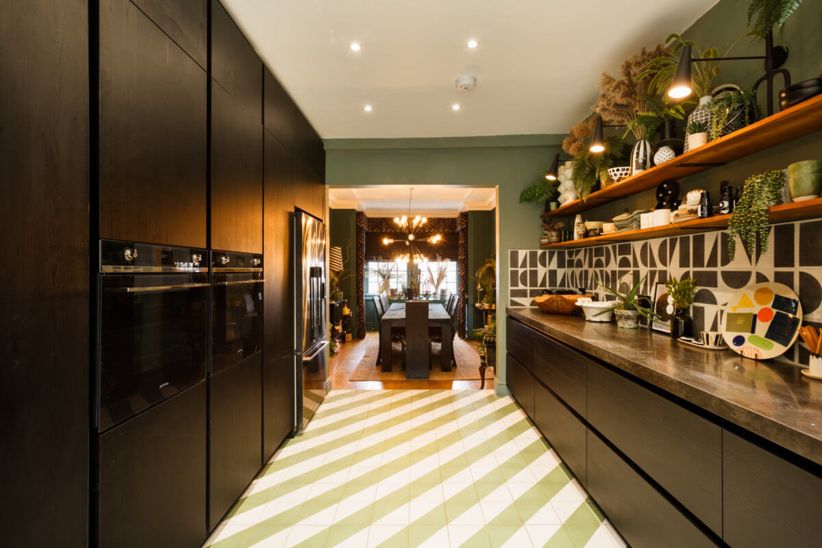 A Colorful Maximalist Home in London 8 black-kitchen-cabinets-green-white-floor-tiles-nordroom