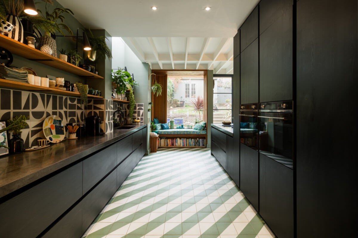 A Colorful Maximalist Home in London 13 black-kitchen-green-walls-diagonal-floor-tiles-reading-nook-nordroom