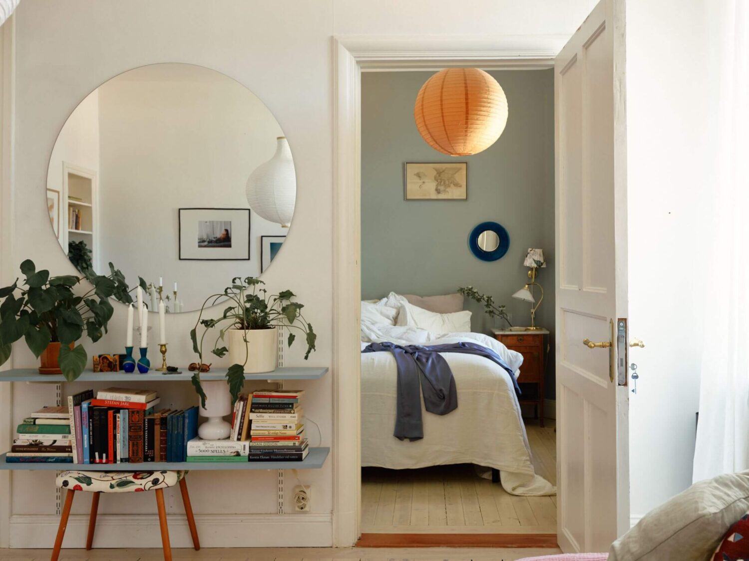 A Charming Apartment with Muted Blue Bedroom 11 blue-bookshelves-large-round-mirror-bedroom-nordroom
