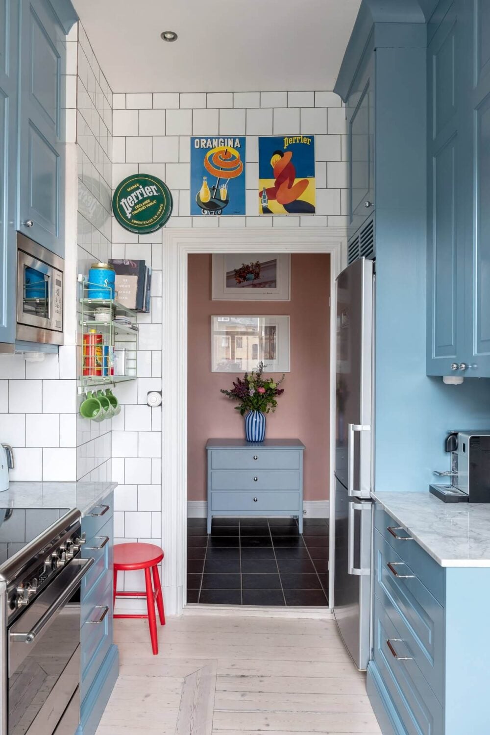 A Nordic Home with Blue Sitting Room and Kitchen 13 blue-galley-kitchen-white-tiles-colorful-apartment-sweden-nordroom