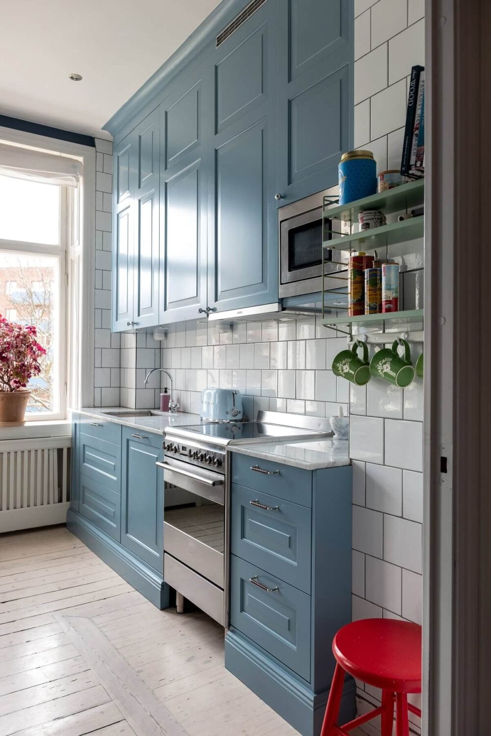 A Nordic Home with Blue Sitting Room and Kitchen 12 blue-galley-kitchen-white-tiles-colorful-home-nordroom