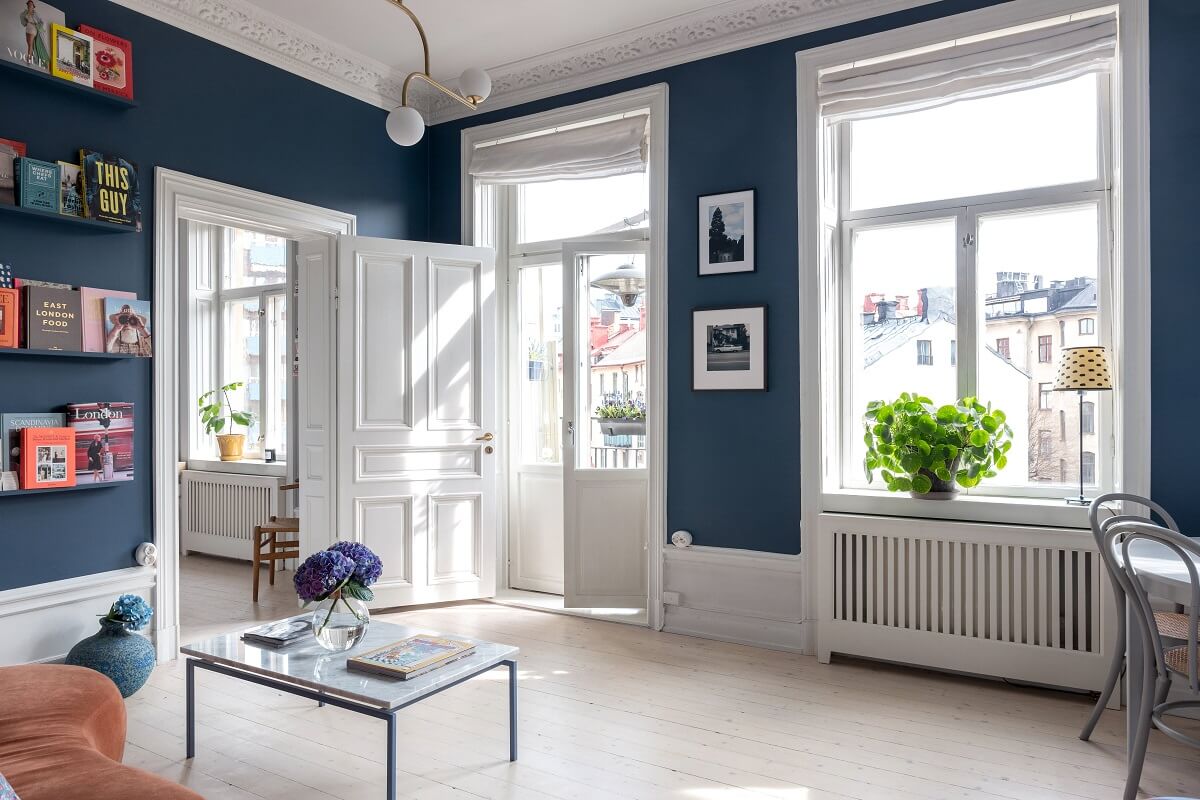 A Nordic Home with Blue Sitting Room and Kitchen 5 blue-living-room-bookshelves-nordroom