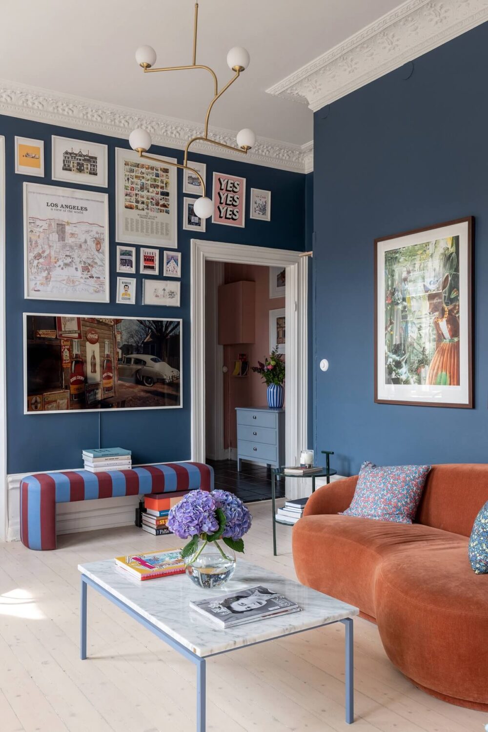 A Nordic Home with Blue Sitting Room and Kitchen 1 blue-sitting-room-gallery-wall-curved-orange-sofa-nordroom