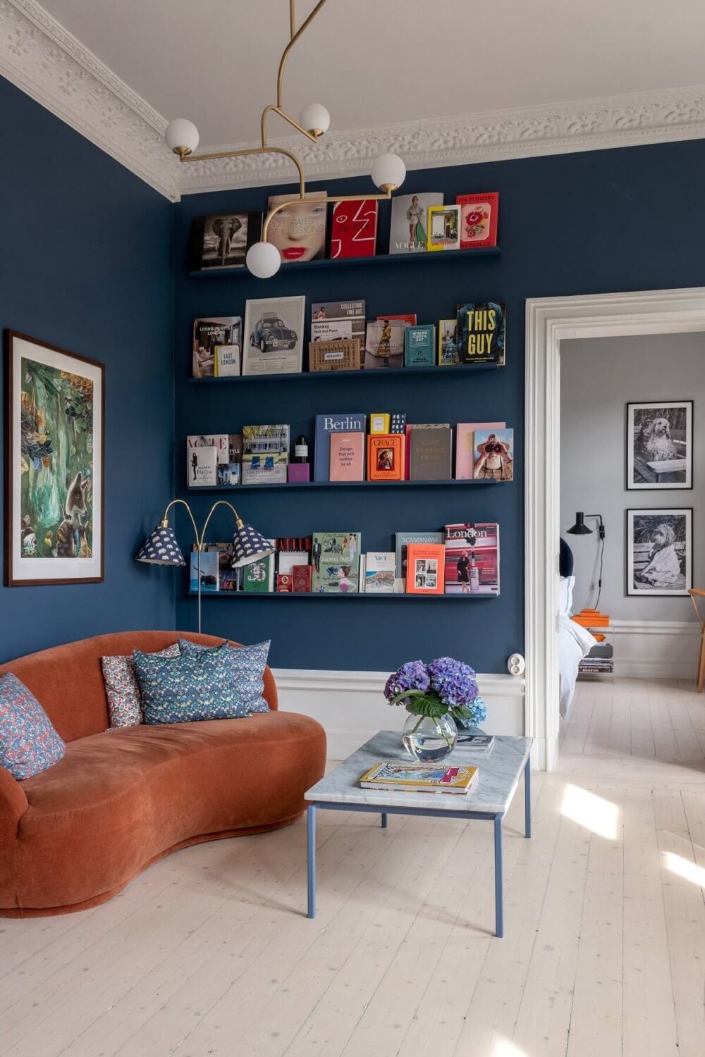 A Nordic Home with Blue Sitting Room and Kitchen 3 blue-sitting-room-orange-curved-sofa-book-ledges-nordroom