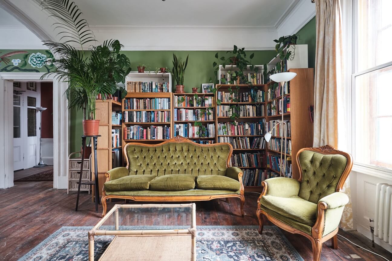A Colorful Eclectic Home in England 7 colorfull-eclectic-sitting-room-bookshelves-antique-green-sofa-nordroom