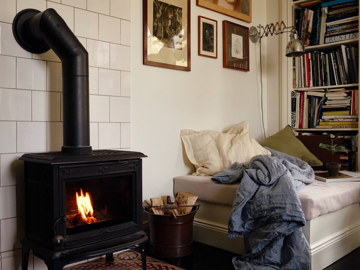 A Cozy Vintage Bohemian Maisonette in Sweden 5 cozy-living-room-sofa-books-fireplace-nordroom