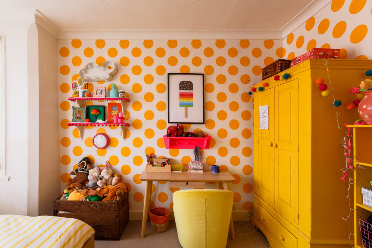 A Colorful Maximalist Home in London 34 desk-yellow-wardrobe-kids-bedroom-polkadot-wallpaper-nordroom