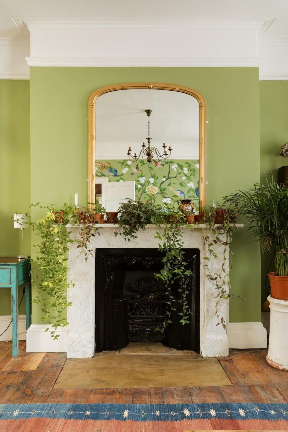 A Colorful Eclectic Home in England 5 fireplace-green-walls-wooden-floor-nordroom