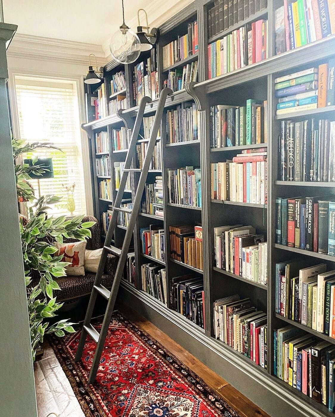 The Top Home Design Trends for 2026: Bold Color, Cozy Corners & Climate-Ready Living 9 green-home-library-reading-nook-window-seat-red-vintage-rug-nordroom