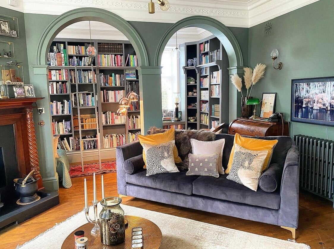 A Wonderful Eclectic Maximalist Home in England 3 green-sitting-room-fireplace-green-walls-arches-home-library-nordroom