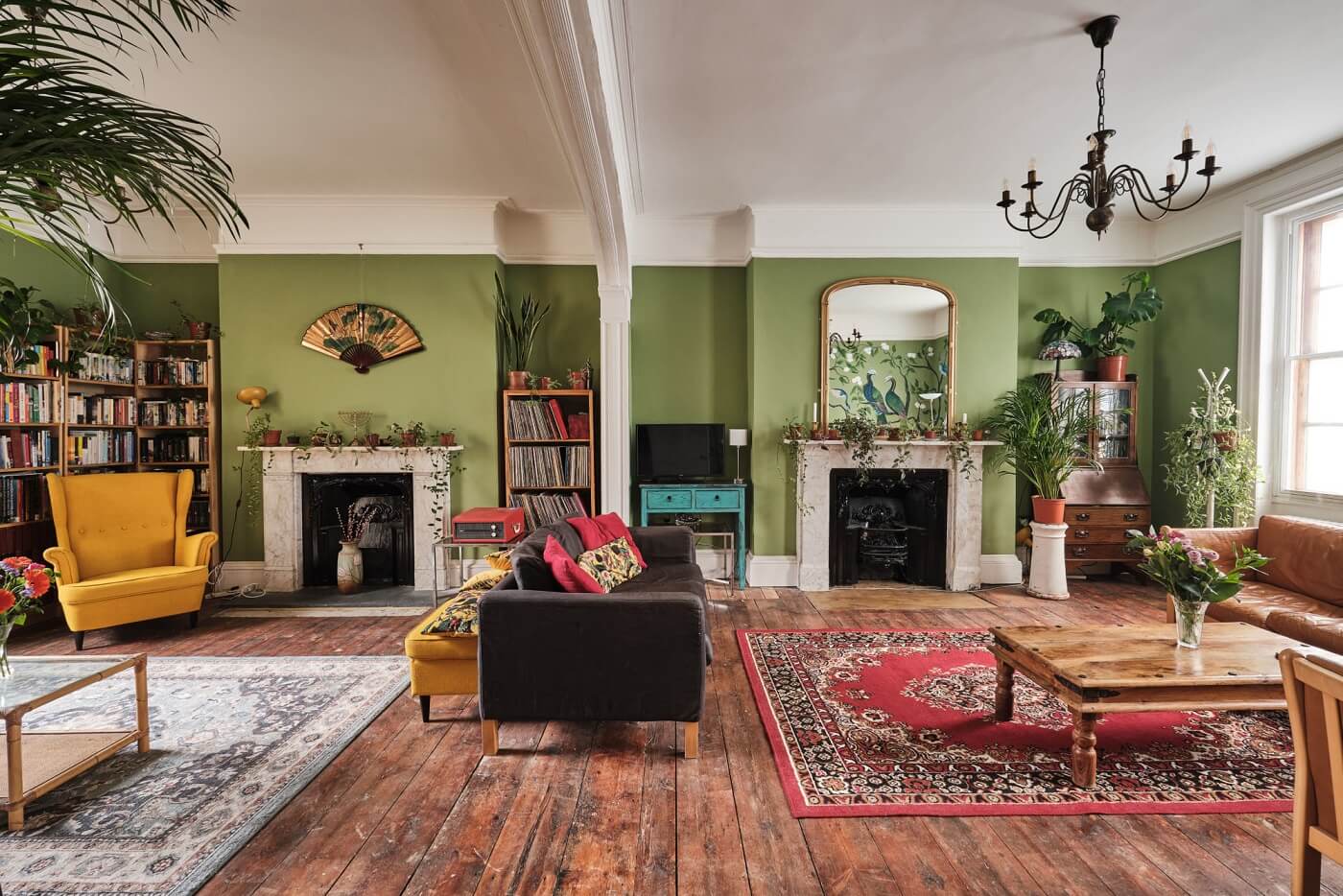 A Colorful Eclectic Home in England 2 green-sitting-room-wooden-floor-fireplace-nordroom