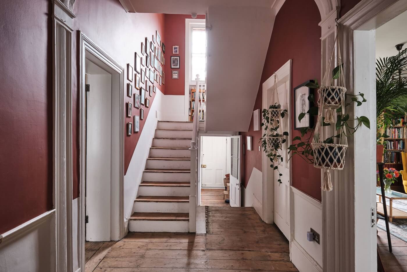 A Colorful Eclectic Home in England 29 hallway-wooden-floor-red-walls-nordroom