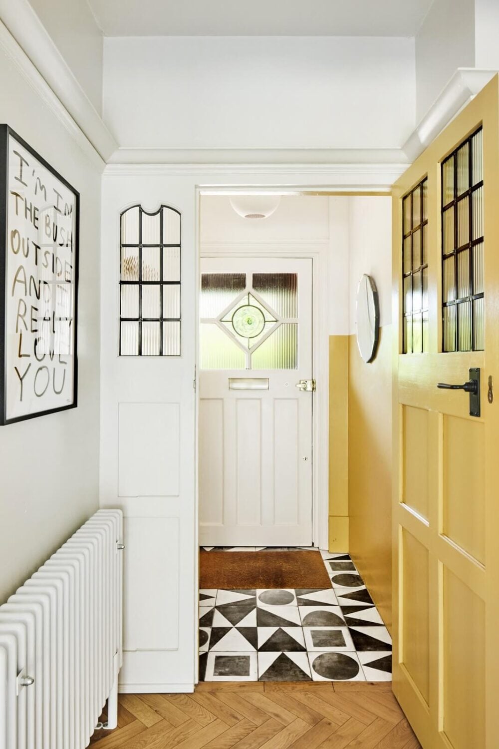 An Arts and Crafts House with Colorful Rooms 13 hallway-yellow-door-geometric-tiles-nordroom