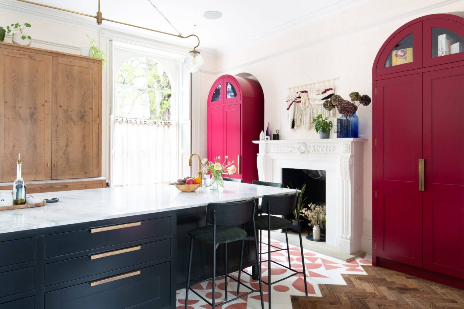 A Colorful Georgian Home in London 3 kitchen-island-bar-stools-bright-pink-arched-cabinets-nordroom