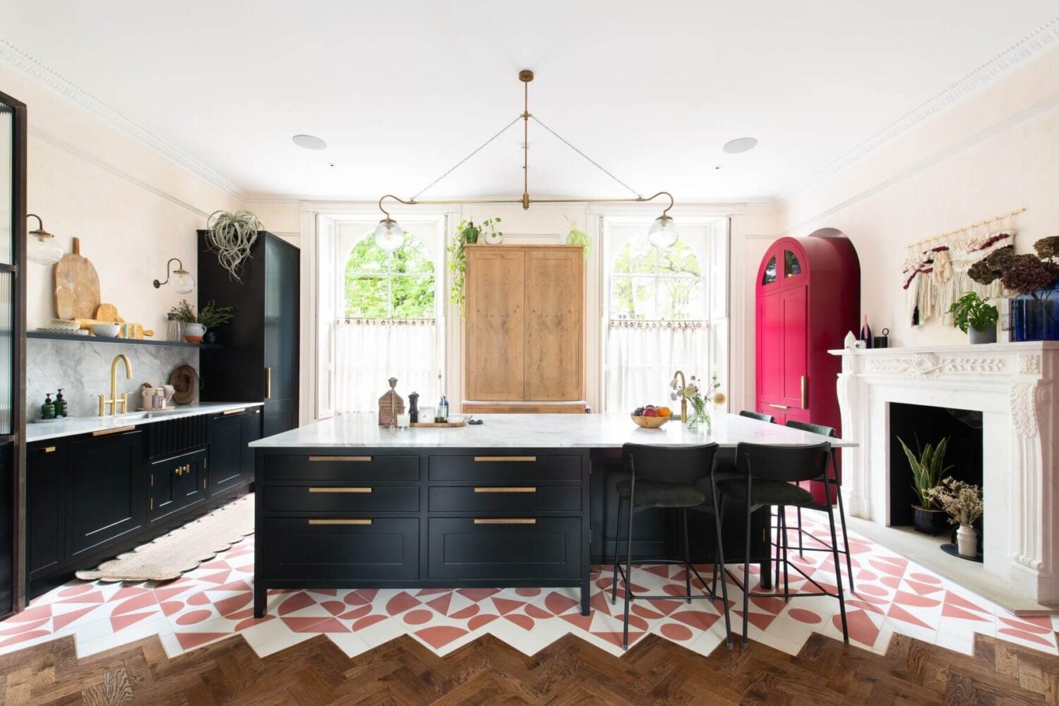 A Colorful Georgian Home in London 2 kitchen-island-dark-blue-cabinets-pink-white-floor-tiles-pink-cabinets-fireplace-nordroom