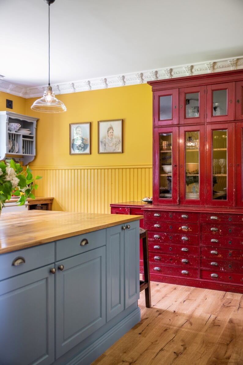 A Colorful Family Home in a Former School Building 12 kitchen-light-blue-island-red-cabinet-nordroom