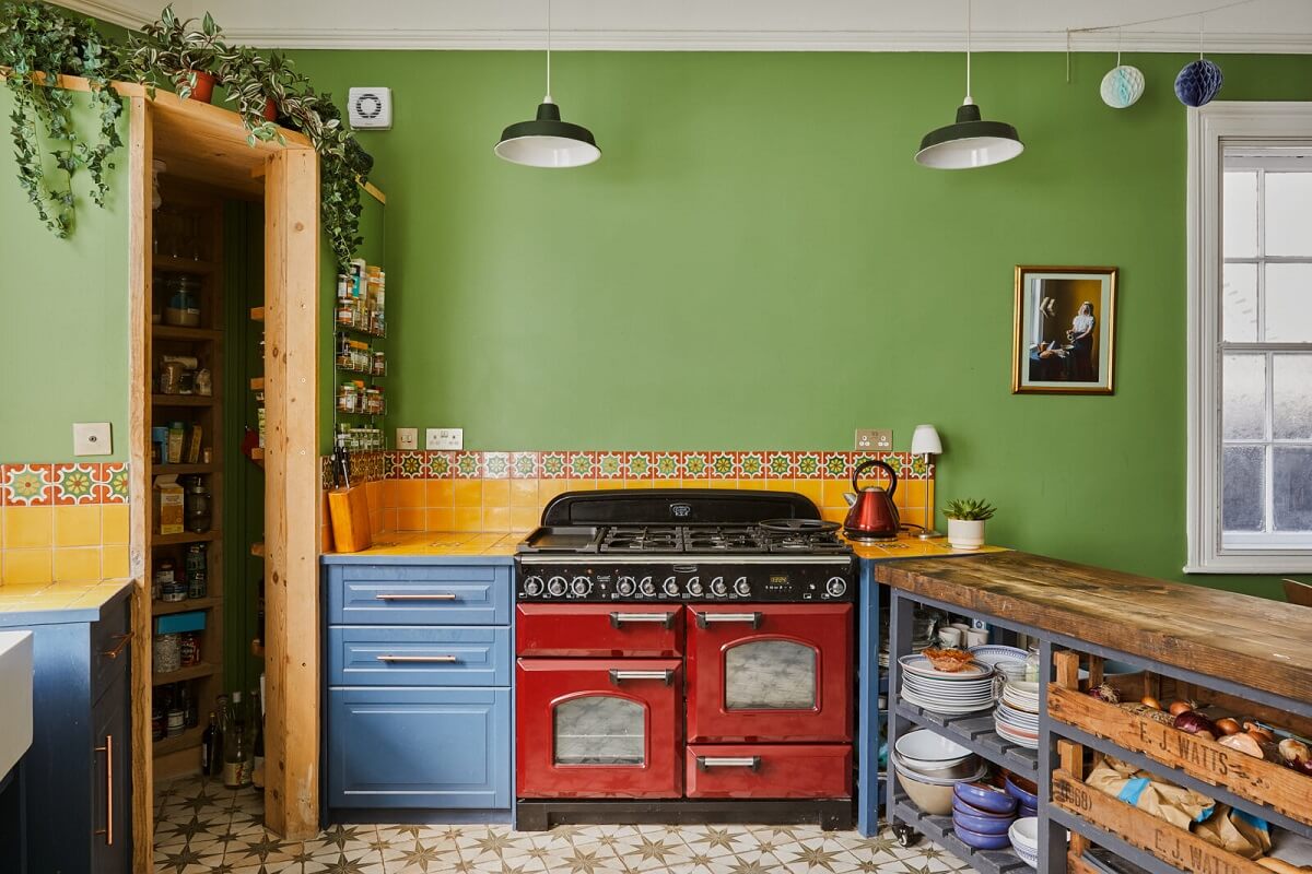 A Colorful Eclectic Home in England 19 kitchen-red-cooker-green-walls-blue-cabinets-nordroom