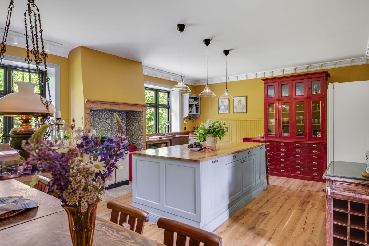 A Colorful Family Home in a Former School Building 8 kitchen-with-island-yellow-walls-wooden-floor-nordroom